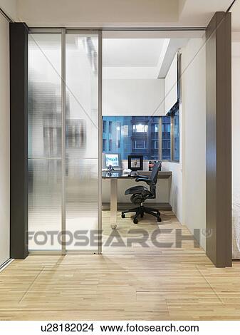 Modern home office with hardwood floor and sliding glass doors View Large Photo Image Picture - Modern home office with hardwood floor and sliding glass doors. Fotosearch