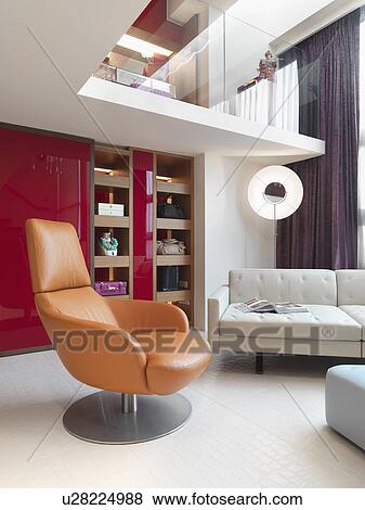 Stock Photo - Modern orange chair in living room. Fotosearch