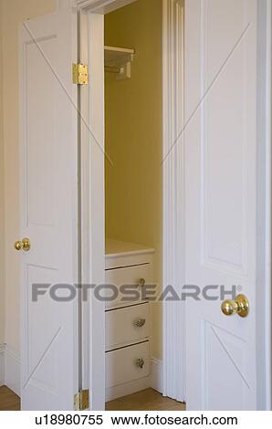 Open Doors To Empty Closet With Dresser Stock Photography