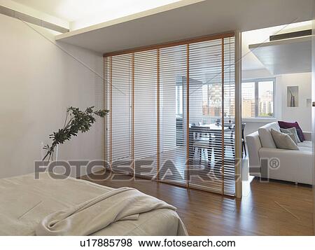Partition separating bedroom from living room View Large Photo Image Stock Photo - Partition separating bedroom from living room. Fotosearch