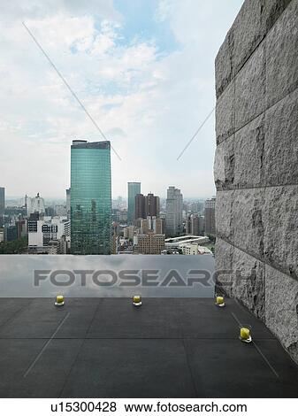 Stock Photo - Patio and reflection pool overlooking city. Fotosearch