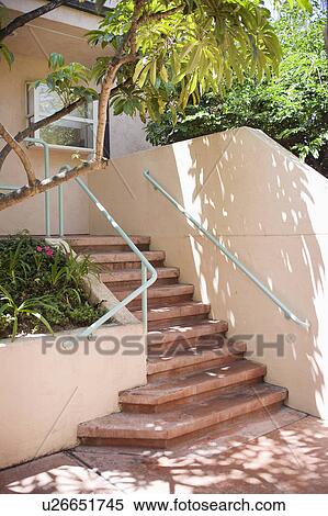 Stock Photography - Pink staircase with green handrail. Fotosearch