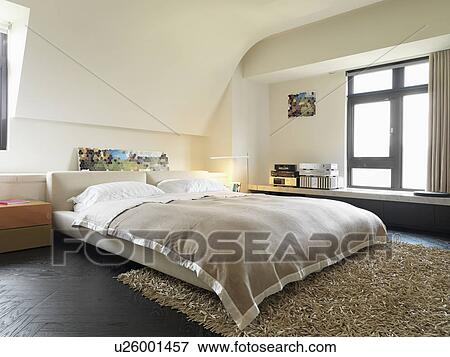 Platform bed in modern bedroom View Large Photo Image Stock Photo - Platform bed in modern bedroom. Fotosearch