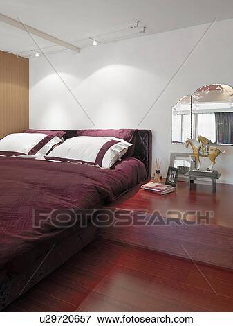 Red bed and hardwood floor in modern bedroom View Large Photo Image Stock Photo - Red bed and hardwood floor in modern bedroom. Fotosearch