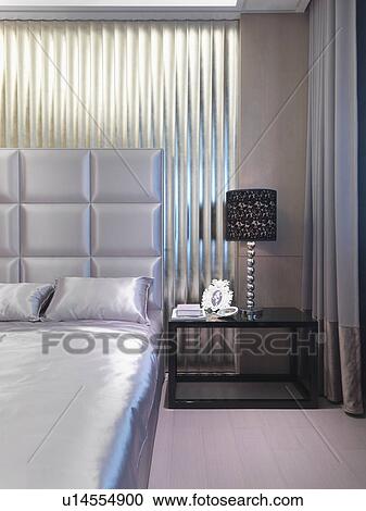 Stock Image - Satin bed with elegant headboard. Fotosearch