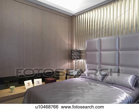 Stock Photograph - Satin bed with elegant headboard. Fotosearch