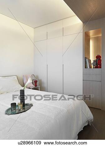 Stock Photo - Serving tray on end of white bed. Fotosearch