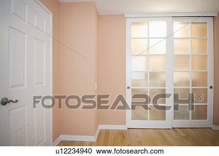 Sliding closet doors in peach colored room View Large Photo Image Stock Image - Sliding closet doors in peach colored room. Fotosearch