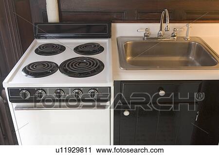 Stock Image - Small stove and kitchen sink. Fotosearch