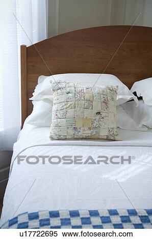 Stock Photography - Small throw pillow on bed. Fotosearch