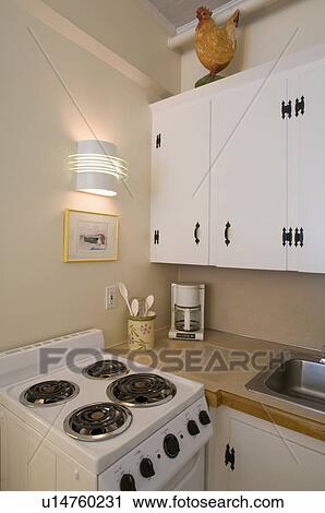 Stock Image - Small white apartment kitchen. Fotosearch