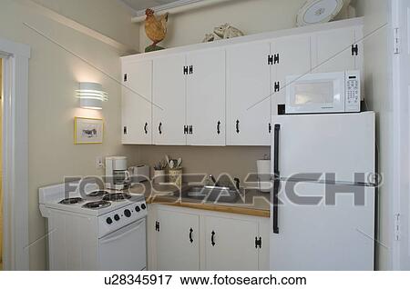 Small white apartment kitchen View Large Photo Image Stock Photo - Small white apartment kitchen. Fotosearch