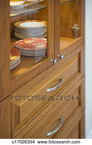 Stacks of decorative plates in china cabinet View Large Photo Image Picture - Stacks of decorative plates in china cabinet. Fotosearch