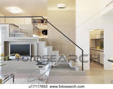 Stock Image - Staircase and entertainment center in modern home. Fotosearch