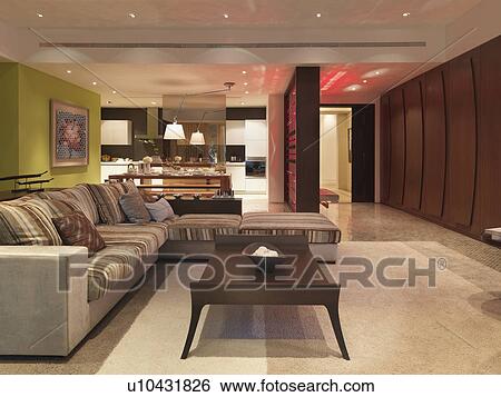 Stock Photograph - Striped sectional sofa in modern apartment style home. Fotosearch