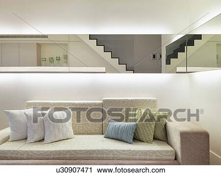 Stock Image - Throw pillows on patterned sofa. Fotosearch