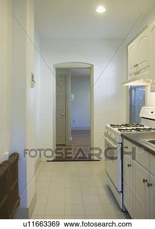 Stock Photo - Tile floor in small apartment kitchen. Fotosearch