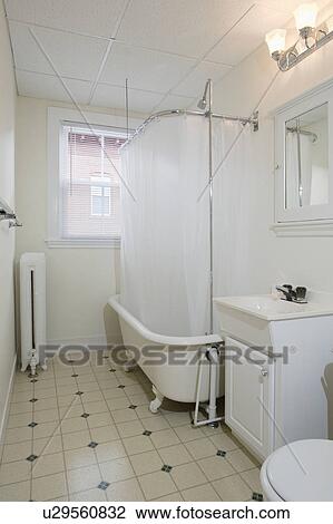 Stock Image - Traditional bathroom with claw foot tub. Fotosearch