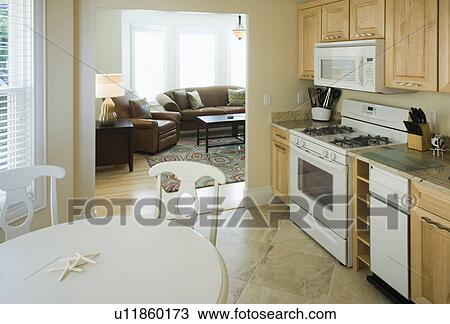 Stock Image - Traditional kitchen with doorway to living room. Fotosearch