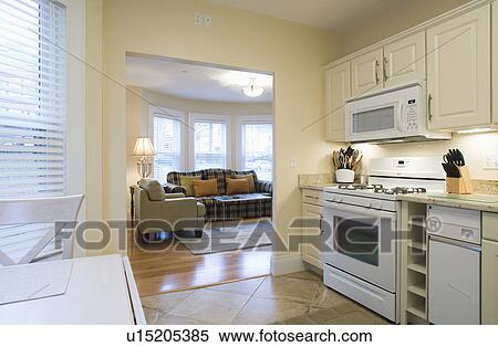 Stock Photography - Traditional kitchen with doorway to living room. Fotosearch