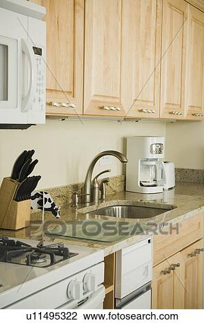 Stock Image - Traditional kitchen with light colored cabinets. Fotosearch