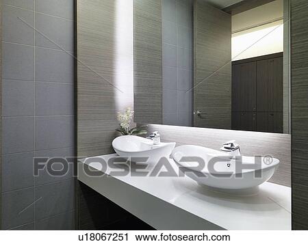 Stock Image - Two white bowl sinks on countertop. Fotosearch