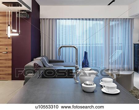 Stock Image - View of kitchen island to living room. Fotosearch