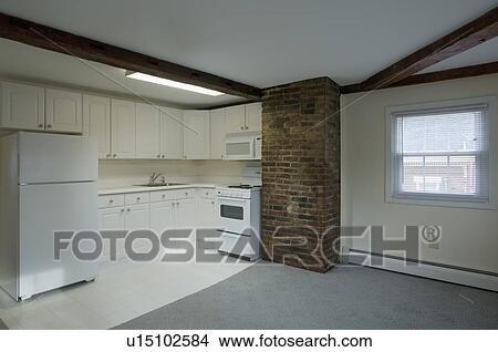 Picture - White stove and kitchen in empty apartment. Fotosearch