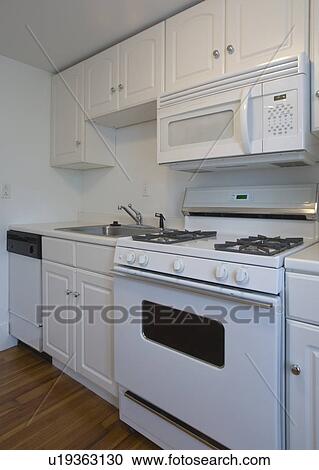 White stove and kitchen in empty apartment View Large Photo Image Stock Image - White stove and kitchen in empty apartment. Fotosearch