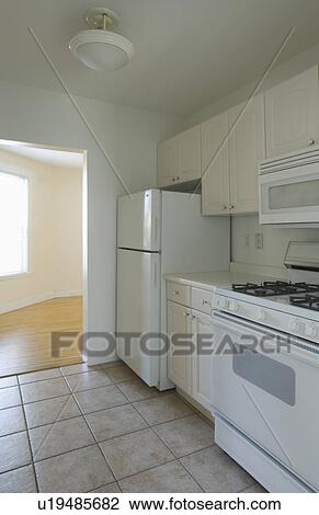 White stove and kitchen in empty apartment View Large Photo Image Stock Image - White stove and kitchen in empty apartment. Fotosearch