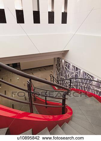 Winding red staircase with handrail View Large Photo Image Stock Image - Winding red staircase with handrail. Fotosearch