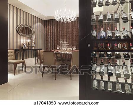 Stock Image - Wine cooler outside elegant dining room. Fotosearch