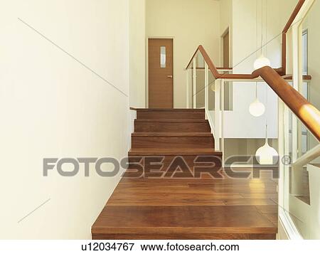 Stock Photo - Wooden steps and hallway in modern home. Fotosearch