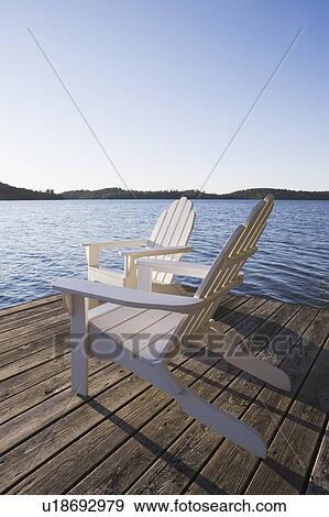 Adirondack chairs on dock View Large Photo Image Stock Photo - Adirondack chairs on dock. Fotosearch