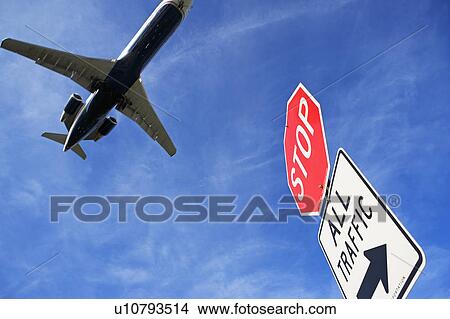 Picture - Airplane and traffic sign. Fotosearch