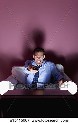 Stock Photo - Angry man using remote control. Fotosearch