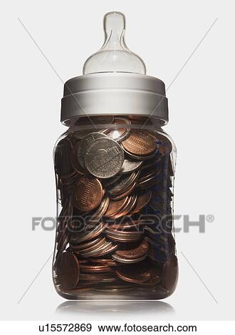 Baby bottle full of coins View Large Photo Image Stock Photo - Baby bottle full of coins. Fotosearch