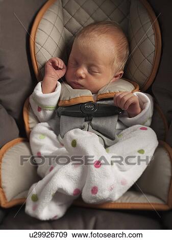 Stock Photo - Baby sleeping in car seat. Fotosearch