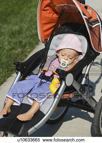 Stock Photography - Baby sleeping in stroller. Fotosearch