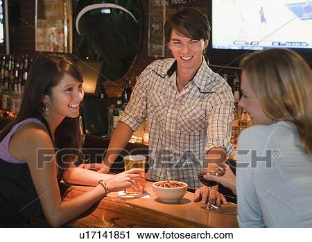 Bartender and patrons View Large Photo Image Stock Image - Bartender and patrons. Fotosearch