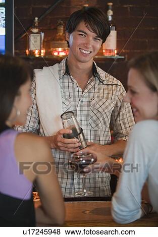 Stock Photo - Bartender making drink. Fotosearch