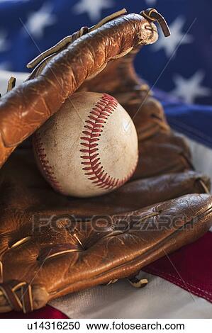 Stock Image - Baseball and American flag. Fotosearch