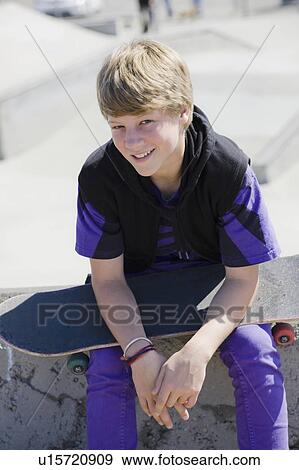 Stock Photo - Boy holding skateboard. Fotosearch