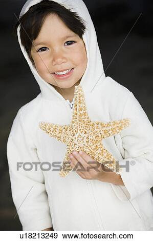 Stock Photo - Boy holding starfish. Fotosearch