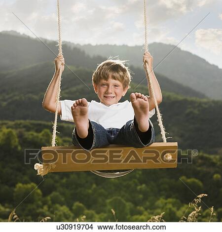 Picture - Boy swinging. Fotosearch