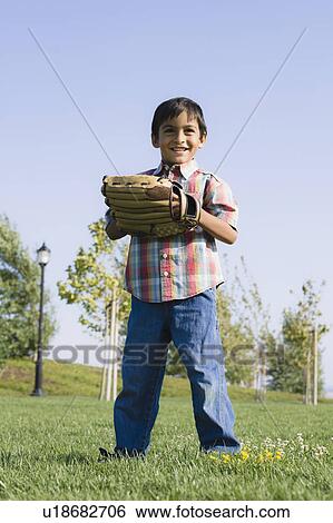 Stock Photograph - Boy wearing baseball glove. Fotosearch