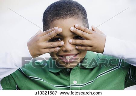 Boy with hands in front of eyes View Large Photo Image Stock Photo - Boy with hands in front of eyes. Fotosearch