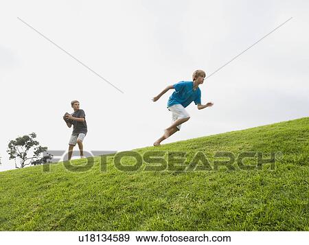 Stock Photo - Boys playing football. Fotosearch