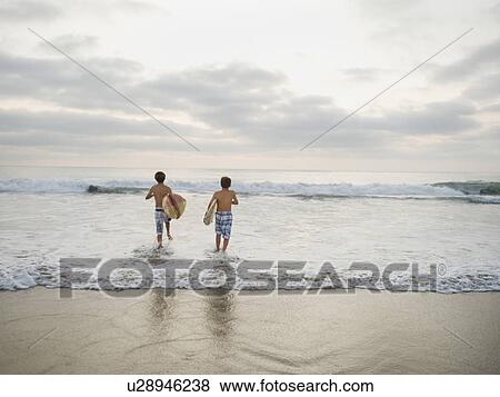 Boys running in surf View Large Photo Image Stock Photo - Boys running in surf. Fotosearch