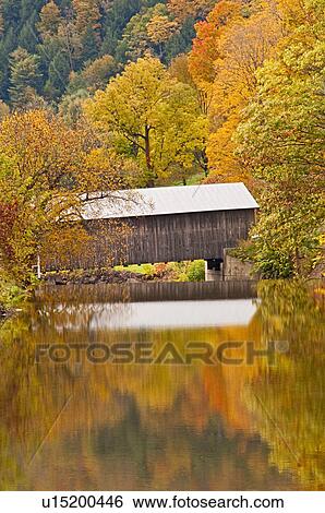 Stock Photograph - Bridge and reflection of fall foliage. Fotosearch